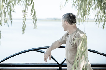 Fototapeta premium Mature European man with a sad philosophical mood. The concept of life after 50 years, problems and depression. Crisis of middle age