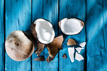 Summer fresh coconuts on blue wooden board with shadow and free space for your decoration. healthy nutrition. 