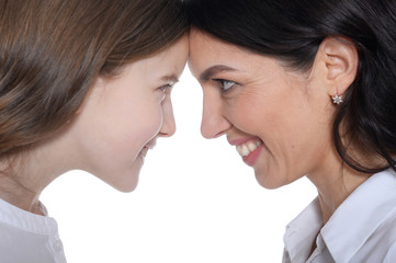 Naklejka premium Portrait of happy mother and daughter posing on white background