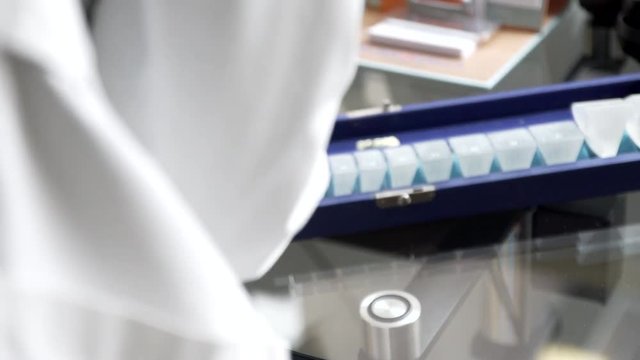 A doctor arranging magnification  or refractor glasses in a optometry clinic.