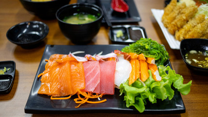 Plate of fresh salmon and tuna sashimi with vegetables,  japanese food