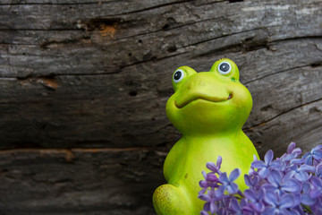 Decorative frog in the garden. Ceramic figurine of a green frog