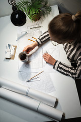 Top view of a young woman architect working