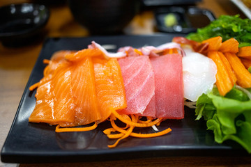 Plate of fresh salmon and tuna sashimi with vegetables,  japanese food