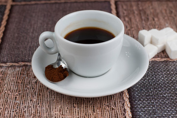 White coffee cup sugar cubes and metal spoon on table.Coffee time