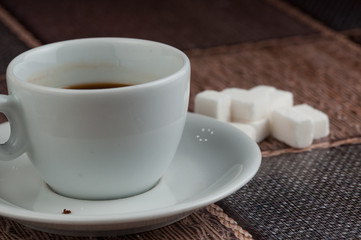 White coffee cup sugar cubes and metal spoon on table.Coffee time