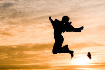 Fototapeta na wymiar Silhouette of woman jumping