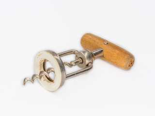 Old wintage bottle opener with wooden handle shot on white.
