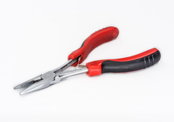 Electrictricians flat end pliers with red and black grips shot on white.