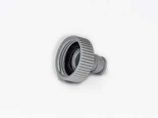 Old watering hose plastic connector shot on white.