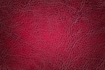 Dark red leather texture background, closeup. Ruby cracked backdrop from wrinkle skin