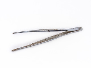 Old rusty zinc coated tweezer shot on white.