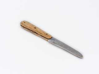 Small stainless steel vintage knife with wooden handle shot on white.