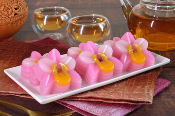 Thai dessert : Layer sweet cake (or Khanom Chan) Thai traditional dessert in pink orchid flowers shaped. One of nine famous Thai auspicious desserts in Thailand.