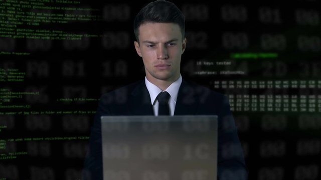Man in suit typing on laptop, software code on background, password hack