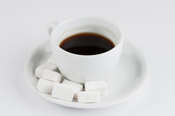 White coffee cup with sugar cubes isolated on white background.
