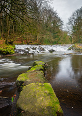 The River Cusher flowing through Clare Glen, Tandragee, County Armagh, Northern Ireland on a cold autumnal day.