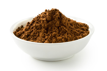 Cocoa powder in a white ceramic bowl isolated on white.