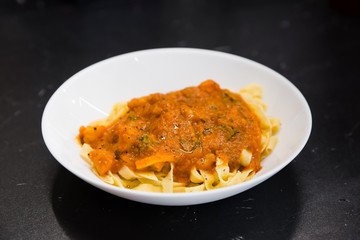 Pasta with sauce in a white plate
