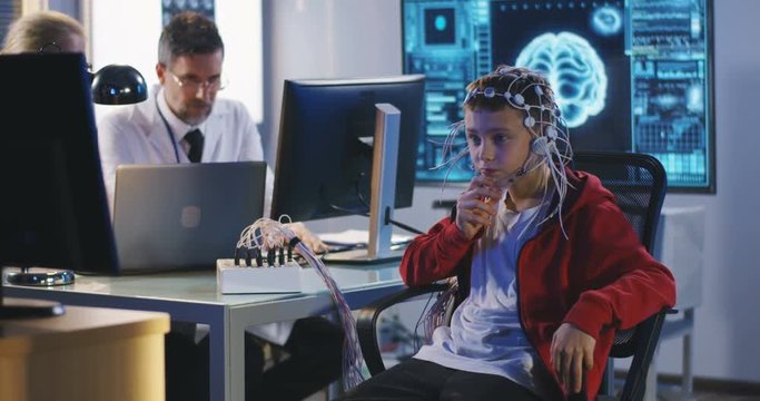Boy undergoing electroencephalography examination