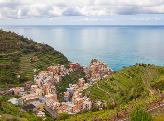 Manarola / Italy - April 28 2019: View above the city of Manarola (Cinque Terre) from the nearby hiking trails.