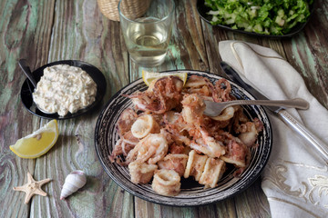 Fried calamari on a wooden table