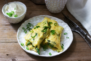 Homemade breakfast of omelet with asparagus and onions and hot coffee. Rustic style.