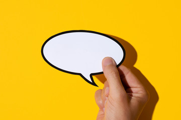 man with a blank speech balloon in his hand