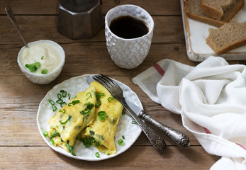 Homemade breakfast of omelet with asparagus and onions and hot coffee. Rustic style.