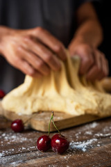 preparing a coca de cireres, a cherry flat cake