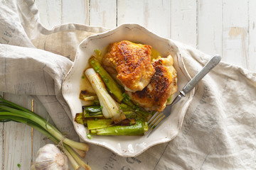 Roasted skin-on chicken thighs with leek and wine sauce