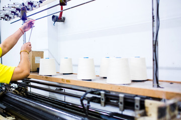 The technician's hand working with textile factory in spinning production line and a rotating machinery and equipment production company.