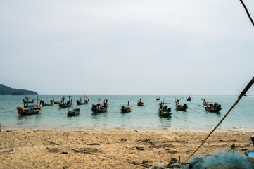 Fishing boats in the sea parked near the beach Near the international airport in Phuket, Thailand.