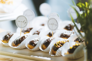 Small fresh eclair with chocolate for wedding ceremony
