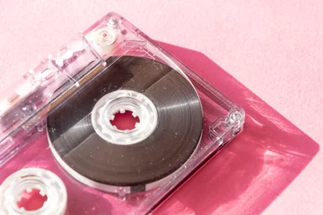 Deurstickers Muziekwinkel retro transparent audio cassette tape on pink background. vintage music technology