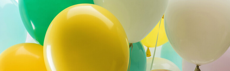 close up view of multicolored decorative balloons, panoramic shot