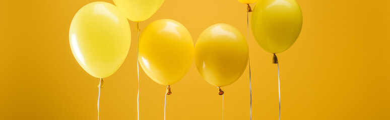 party bright minimalistic balloons on yellow background, panoramic shot