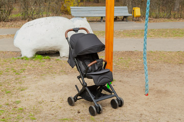 Beautiful baby carriage in the park. New design.