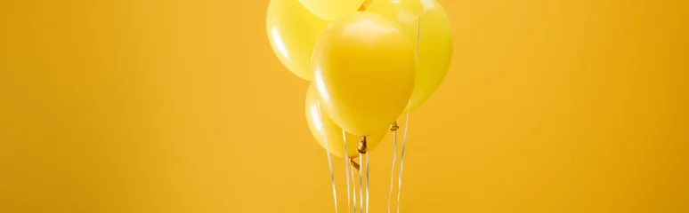 Poster festive minimalistic decorative balloons on yellow background, panoramic shot © LIGHTFIELD STUDIOS