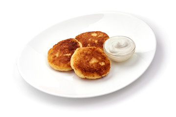 Cottage cheese pancakes, close-up, isolated on white background