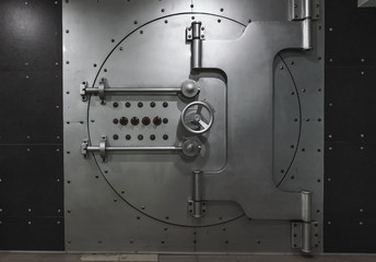 Closed steel bank vault door, close-up. Bank vault.