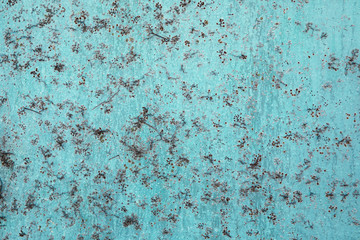 Rusty metal textured blue color surface with weathered floral pattern