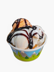 Coconut milk ice cream and tea ice cream topped with chocolate sauce in a paper cup on a white background, isolate