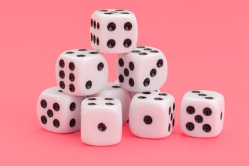 Gaming dice on pink background. Concept for games.