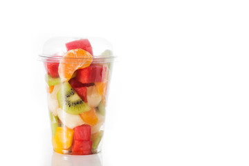 Fresh cut fruit in a plastic cup isolated on white background