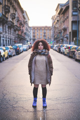 Obraz premium portrait of young brunette woman standing in the street and looking camera