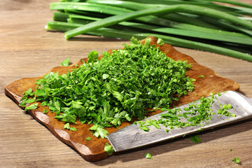 Cooking in the kitchen. Greenery. Green onions. Knife and cutting board