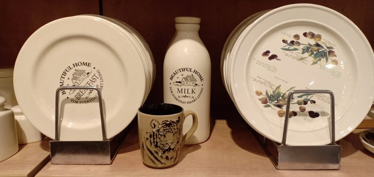 set of cups and saucers with milk bottle