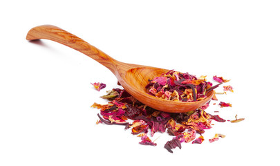 Dried tea on a wooden spoon, isolated on white