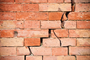Deep crack in old brick wall - concept image